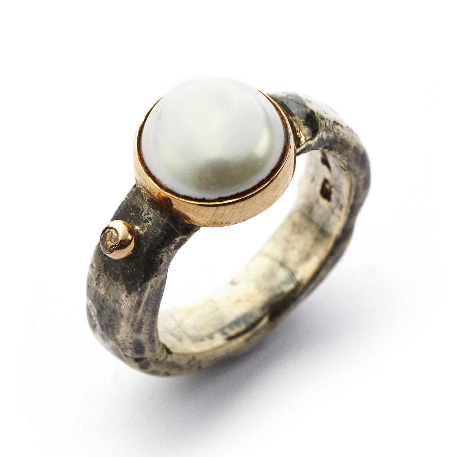 Ring of silver with one brilliant cut diamond and big pearl in gold collet